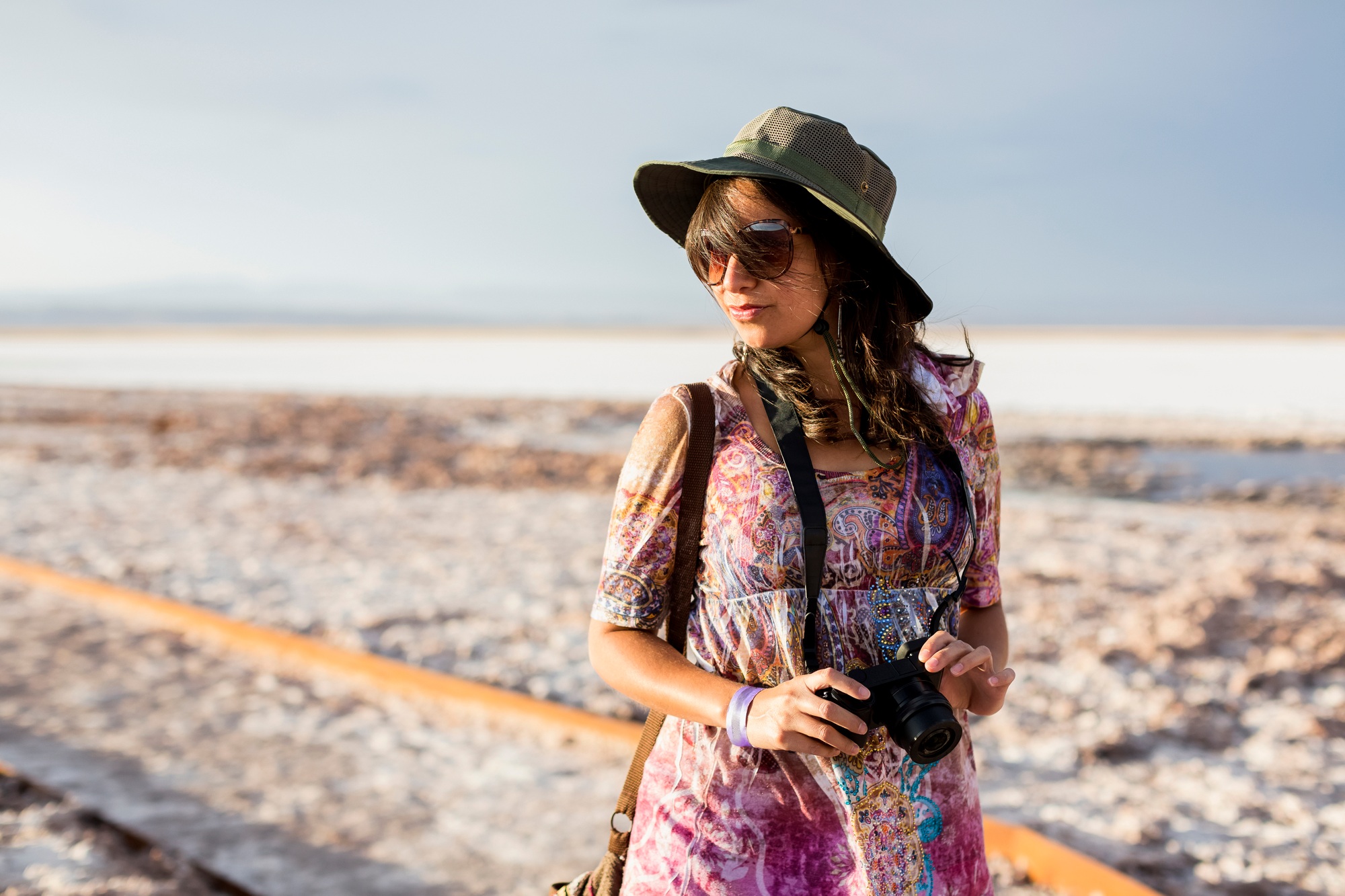 Chile, San Pedro de Atacama, woman with camera in the desert